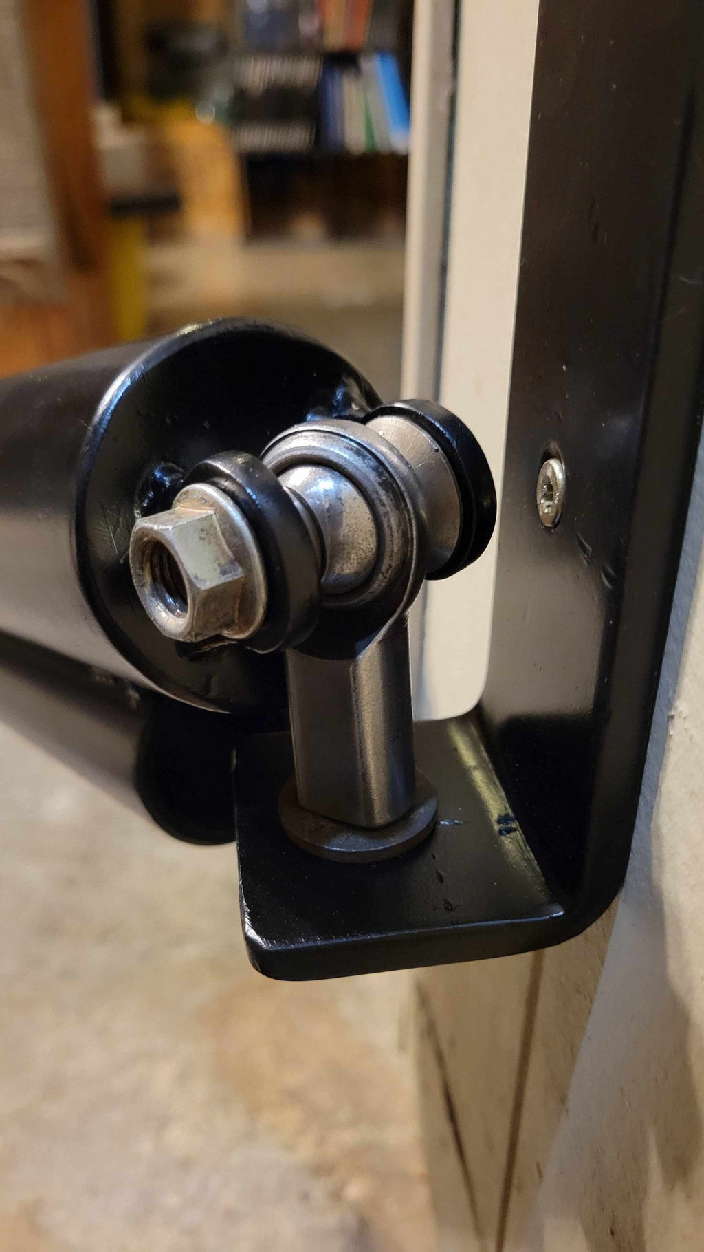 Close-up of the Wall Mounted Landmine's pivot joint and mounting bracket, showing durable construction for weightlifting exercises.