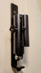 Front view of the Wall Mounted Landmine featuring adjustable knobs and dual sleeve design for 1" and 2" barbells in home gym setups.
