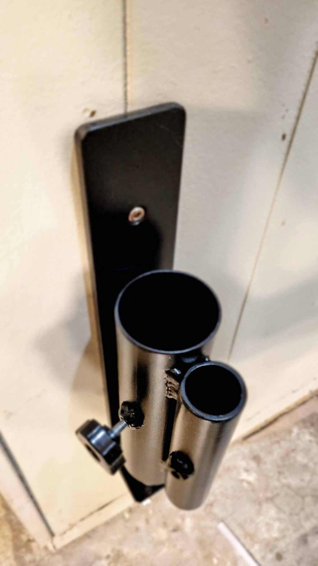Top-down view of the Wall Mounted Landmine's dual barbell sleeves, highlighting compatibility with standard and Olympic bars.