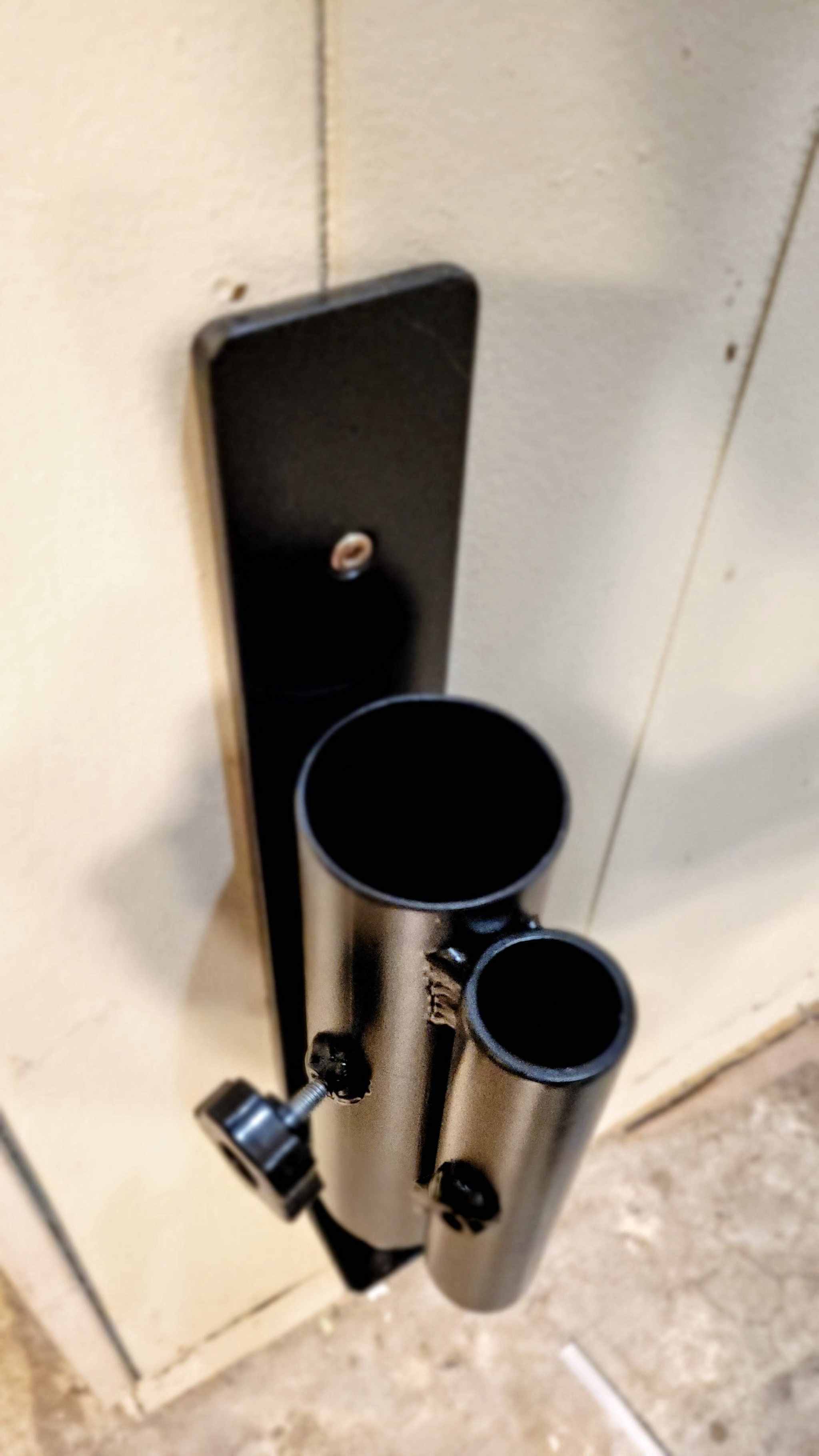 Top-down view of the Wall Mounted Landmine's dual barbell sleeves, highlighting compatibility with standard and Olympic bars.