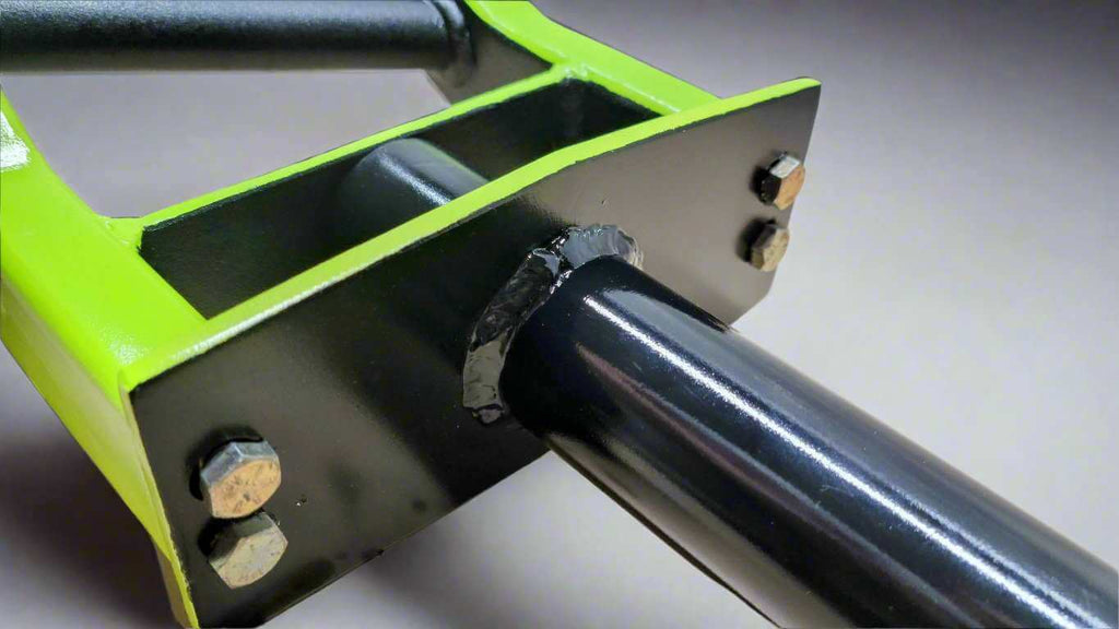 Close-up of Belle Mere Fitness Swiss Barbell showing welded steel construction and bolt-secured sleeve for heavy-duty performance and durability.